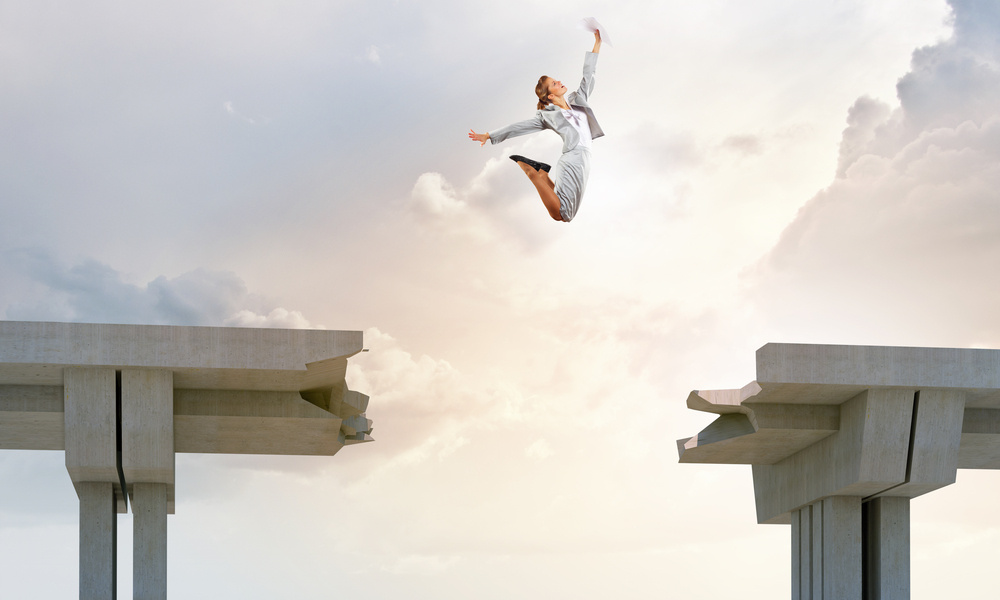 Young woman jumping over a gap in the bridge as a symbol of risk Young woman jumping over a gap in the bridge as a symbol of risk